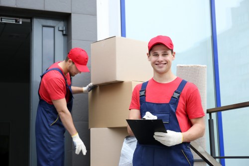 Removalists carrying furniture through a residential property in Enfieldwash
